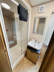 a bathroom with a shower and a sink at Golden Sands, Ingoldmells, 6 berth in Ingoldmells