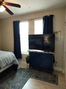 a bedroom with a flat screen tv and a bed at Buena Vista home in Visalia