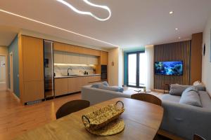 a living room with a couch and a table at Grandstay Apartments in Durrës