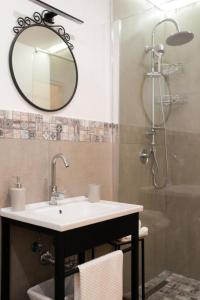 a bathroom with a sink and a shower with a mirror at Le Casine di Spaccanapoli in Naples