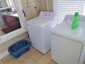 a washer and dryer in a room with a window at Florida Vacation House - Pensacola East Hill in Pensacola