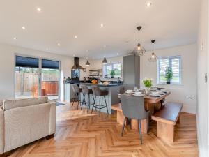 a kitchen and living room with a table and chairs at Cedar Lodge in Mansfield Woodhouse
