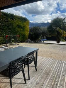 a ping pong table sitting on a wooden deck at Logement ICARE 5km de Crolles, Soitec , ST in Lumbin