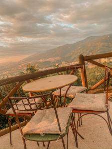 a table and chairs on a balcony with a view at HACIENDA EL ENSUEÑO in Floridablanca