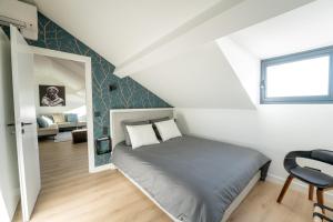 a small bedroom with a bed in a attic at Monte Carlo Monaco Border - luxury, modern, cozy with home feelings and See View in Beausoleil