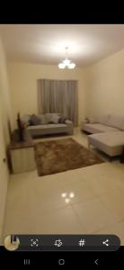 a view of a living room with a couch and a living room at Orient Tower - Tower C - Ajman city in Ajman 