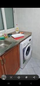 a kitchen with a sink and a microwave at Orient Tower - Tower C - Ajman city in Ajman 