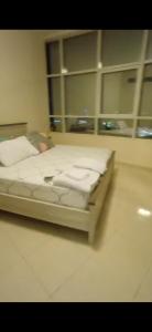 a white bed in a room with shelves at Orient Tower - Tower C - Ajman city in Ajman 
