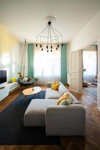 a living room with a couch and a table at Modern, design lakás a Margit-sziget mellett in Budapest
