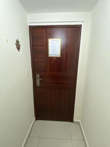 a brown door in a room with a white floor at Urban Retreat in ArraijÃ¡n