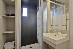 a white bathroom with a sink and a shower at Nice cottage with terrace in Saubrigues - Welkeys in Saubrigues