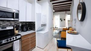 una cucina con elettrodomestici bianchi e un soggiorno di 24-3 Prime Gramercy New Studio W D Terrace a New York