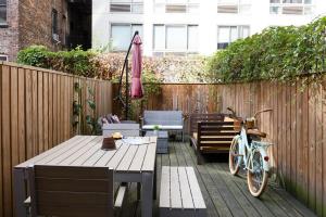 a patio with a table and a bike next to a fence at 24-3 Prime Gramercy New Studio W D Terrace in New York