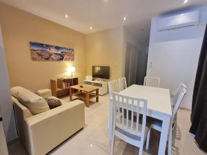 a living room with a white table and a couch at Tarxien - Lovely 3 bedroom unit in Tarxien