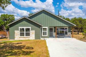 a green house with a garage at The Lake House in Canyon Lake