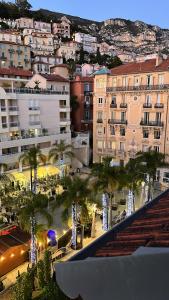 a view of a city with palm trees and buildings at Monte Carlo Monaco Border - luxury, modern, cozy with home feelings and See View in Beausoleil