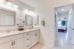 a bathroom with two sinks and a mirror at Beautiful Venice Getaway, 4 Mi to Manasota Beach! in Venice