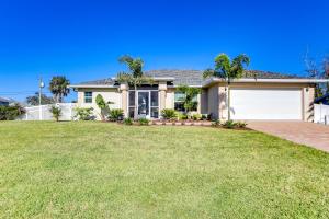 a house with a garage and a grass yard at Beautiful Venice Getaway, 4 Mi to Manasota Beach! in Venice
