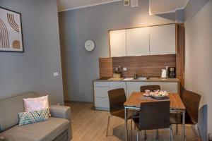 a living room and kitchen with a table and a couch at Sunset A23 przy plaży in Pobierowo