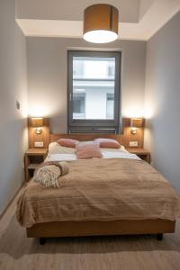a bedroom with a large bed with a window at Sunset A23 przy plaży in Pobierowo +38 photos