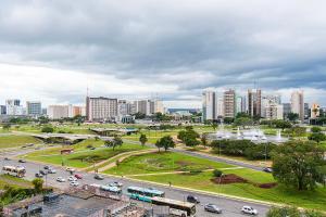 a city with cars on a road in front of buildings at GS Properties - Hotel Líder in Brasilia