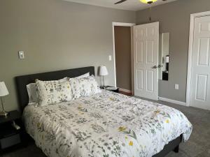 a bedroom with a bed with a floral comforter at Carter #3 Two bedroom unit near Xavier Downtown in Cincinnati