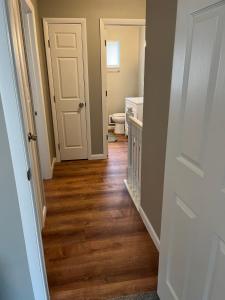 a hallway with a bathroom with a toilet and a door at Carter #3 Two bedroom unit near Xavier Downtown in Cincinnati