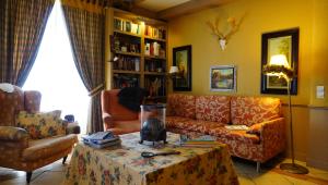 a living room with a couch and a table at Au Bonheur De Ce Monde in Boudreville