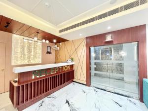 a hotel lobby with a reception counter and a window at HOTEL VEDANGAM INN ! VARANASI - Forɘigner's Choice ! fully Air-Conditioned hotel with Parking availability, near Kashi Vishwanath Temple, and Ganga ghat in Varanasi