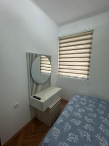 a bedroom with a vanity and a mirror and a bed at Viktor in Gornje Mladice