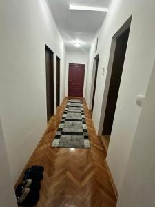 a hallway with a door and a checkered floor at Viktor in Gornje Mladice