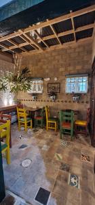 a dining room with colorful chairs and a table at Hotel Bugambilia, Pueblito Boyacense in Duitama