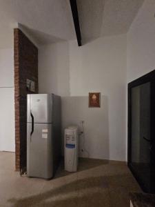 a kitchen with a refrigerator and a trash can at Casa LH en Villa María, Córdoba in Villa María