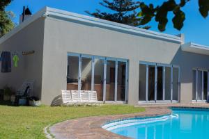 a house with a pool in front of it at Meah lane , TableView in Cape Town