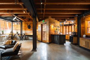 a living room with wooden walls and a bar at Gravity Haus Truckee-Tahoe in Truckee