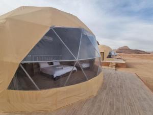 a tent in the middle of the desert at Glow of Wadi Rum Camp in Wadi Rum