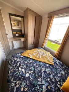 - une chambre avec un lit et une fenêtre dans l'établissement North Shore, Skegness, new 8 berth caravan, à Lincolnshire