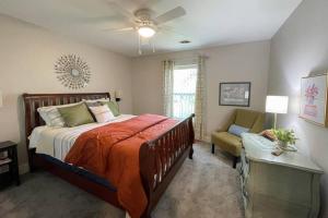 a bedroom with a bed and a chair and a window at New Beautiful 3 Bedroom Condo in Bettendorf in Bettendorf