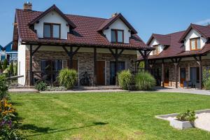 a house with a lawn in front of it at Domki Nordic in Władysławowo