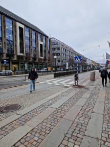 a person walking down a street in a city at Gothenburg City Apartment in Gothenburg