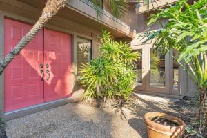 a red front door of a house with plants at Resort Palm Retreat in Wesley Chapel +42 photos