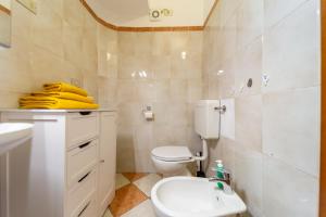 a bathroom with a white toilet and a sink at A Casa di Luca in Parma