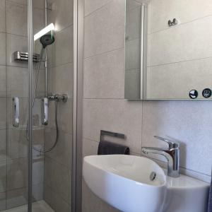 a bathroom with a sink and a shower at Ferienwohnung Trattler in Chieming