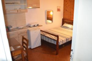 a small kitchen with a small bed in a room at Nick Apartment in Zakynthos Town