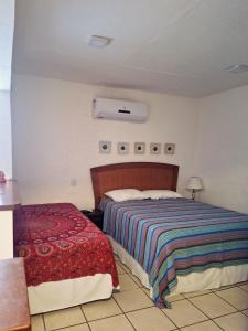 A bed or beds in a room at Apartamento Queen Centro Histórico - Vila Ilhabela