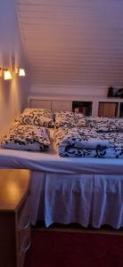 a bed in a room with two pillows on it at Coloria - kotisi Rovaniemellä, luonnollisesti in Rovaniemi