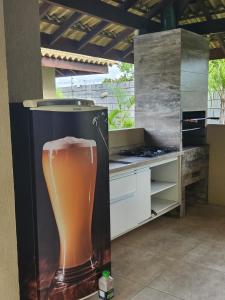 a picture of a glass of beer in a refrigerator at Village Verano Guarajuba in Guarajuba