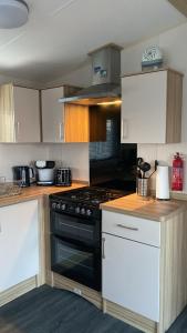 a kitchen with a stove and a counter top at Beach life in Lossiemouth