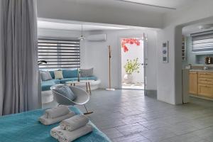 a room with a bed with pillows on it at Yades House Paros in Naousa +37 photos
