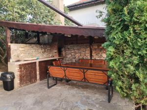 a bench sitting under awning in a patio at Sunset House in Varna City